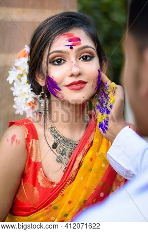 Young Couple Playing With Colors On The Festival Of Colours Called Holi, Popular Hindu Festival Cele