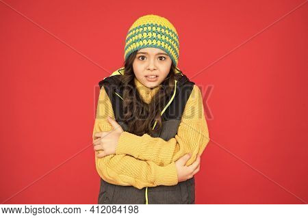 It Might Be Too Cold To Trek Outside. Little Child Feel Cold Red Background. Small Girl Shiver In Co