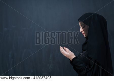 Portrait of young Muslim woman making dua