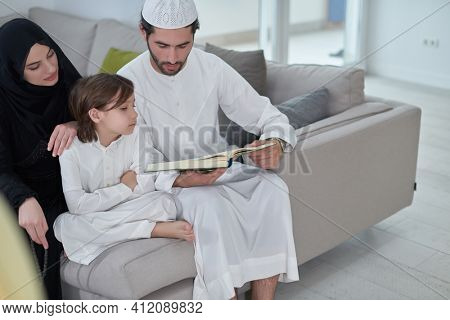 Young muslim family reading Quran during Ramadan