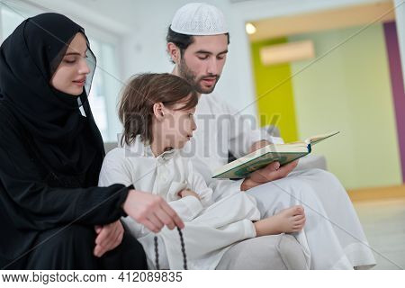 Young muslim family reading Quran during Ramadan
