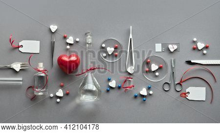 Chemistry Of Love. Creative Flat Lay On Grey Paper. Top View With Chemical Glassware, Petri Dishes, 