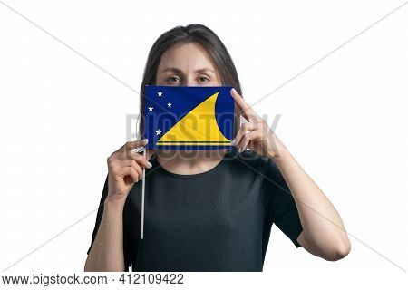 Happy Young White Woman Holding Flag Tokelau Flag And Covers Her Face With It Isolated On A White Ba