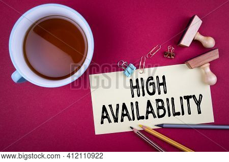 High Availability. Tea Cup And Office Supplies On A Red Background