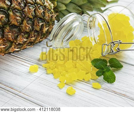 Sweet Pineapple Succade Cubes On White Wooden Background