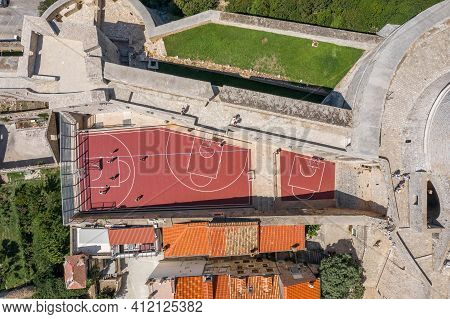 Aerial Overhead Drone Shot Of Basketball Court By Fort Minceta Of Dubrovnik City Wall In Croatia Sum