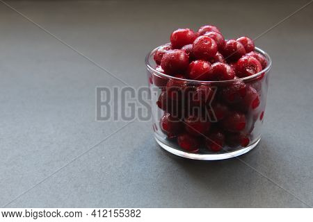 Food Photo Frozen Cherries Or Cherries In A Glass Glass Tableware On A Black Background With A Place