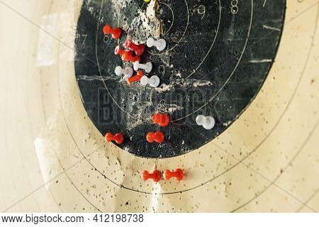 The Target Is Marked With Pins. Colored Pins Indicate On The Target In The Dash The Shooters Hit Fro