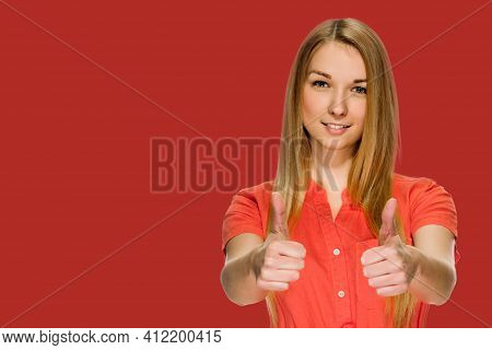Portrait Of Happy Smiling Blonde Showing Thumbs Up On Red Background