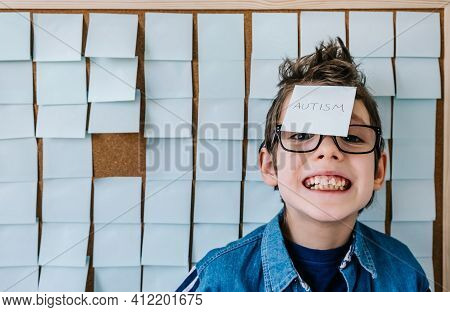 Autism Awareness Funny Concept. Portrait Of Cheerful Autism Boy With Glasses In Blue Shirt Front A B