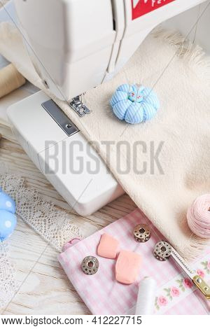Sewing machine, tools and supplies. Hobby, crafting, creativity, free time at home concept.