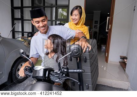 Asian Muslim Family Riding Motorbike Scooter Together Traveling With Kid