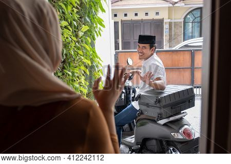 Asian Husband Waving Goodbye To His Wife Before Leaving Out By Motorcycle