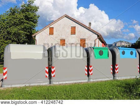 Four Special Bins For The Separate Collection Of Uraban Solid Waste In The City Street