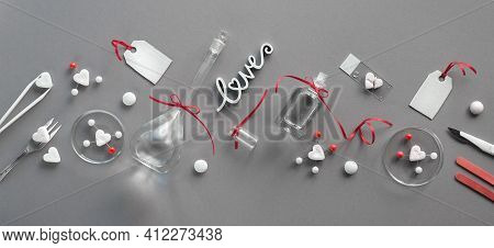 Chemistry Of Love. Creative Flat Lay On Grey Paper. Top View With Chemical Glassware, Petri Dishes, 