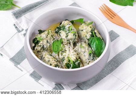 Gnudi With Ricotta And Spinach Served With Melted Butter With Garlic In Ceramic Bowl. Italian Meal