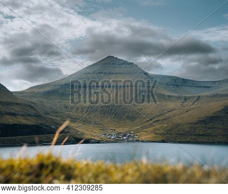 Sun Shining On Small Village On The The Northern Most Village On Stremoy In The Faroe Islands With B