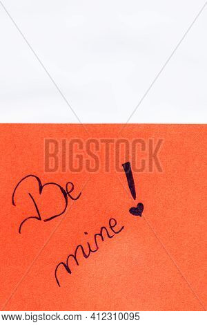Be Mine Handwriting Text Close Up Isolated On Orange Paper With Copy Space. Writing Text On Memo Pos