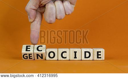Ecocide Or Genocide Symbol. Businessman Turns Cubes And Changes The Word Genocide To Ecocide. Beauti