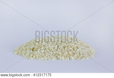 Uncooked Arborio Rice. Risotto Rice On White Background. Pile Of Arborio Short Grain White Rice Isol