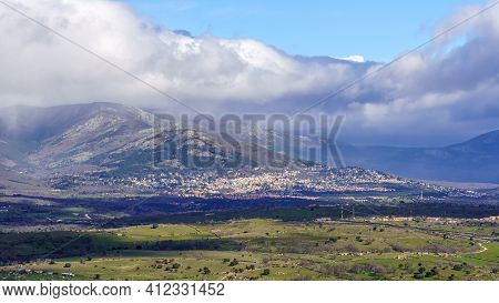 Aerial View Green Mountain Landscape With Dark Clouds And Villages With Houses On The Mountainside. 