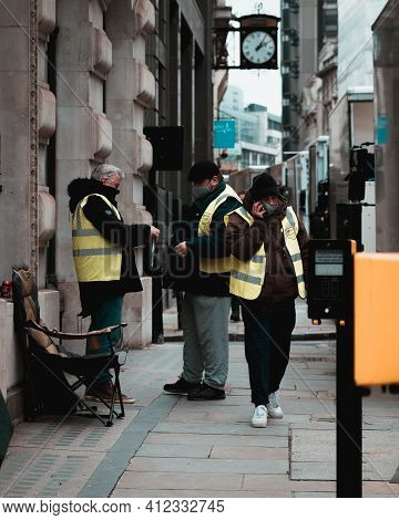 London Uk February 2021 Three Workers On The Streets Of London Wearing Yellow High Visibility Jacket
