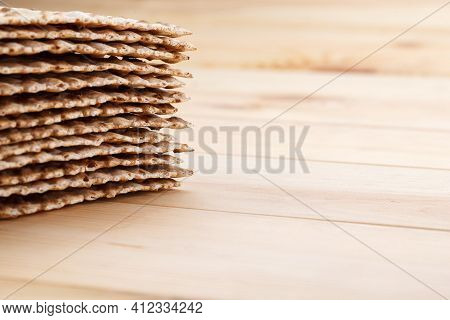 Jewish Matzah On Wooden Rustic Background. Jewish Traditional Passover Bread. Pesach Celebration Sym