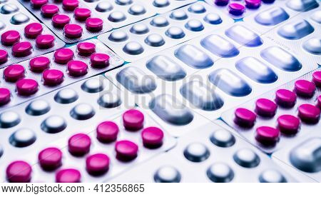 Pink Tablets Piils In Blister Pack And Silver Aluminium Foil Pack Of Pills. Pharmaceutical Industry.