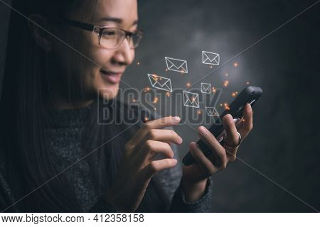 Woman Sending E-mail Message To Mailing List Contacts Using Smartphone,