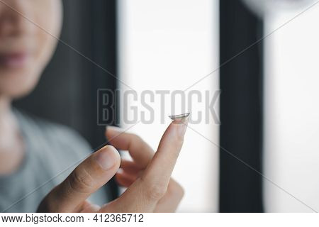 Women Holds Finger On A Contact Lens.