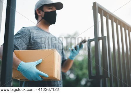 New Normal Life Style. Home Delivery Shopping Box Man Wearing Gloves And Protective Mask Delivering 