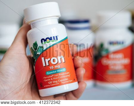 Moscow, Russia - March 09, 2021: Jar With Iron Capsules In Female Hand And Others Nutrition Suppleme