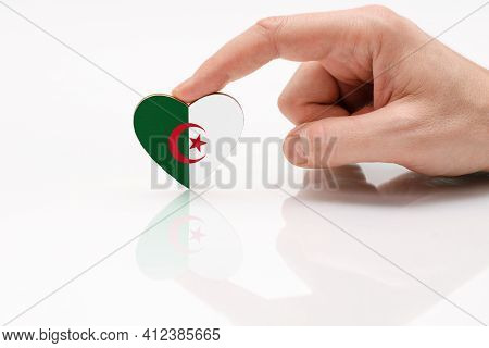 Algeria Flag. Love And Respect Algeria. A Man's Hand Holds A Heart In The Shape Of The Algeria Flag 
