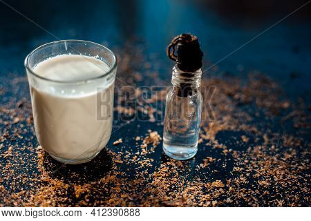 Glycerine Skin Cleanser On A Black Surface. Shot Of Glycerine In A Glass Bottle Along With A Glass O
