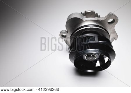 Water Pump Of The Internal Combustion Engine Cooling System. Contrasting On A Gray Gradient