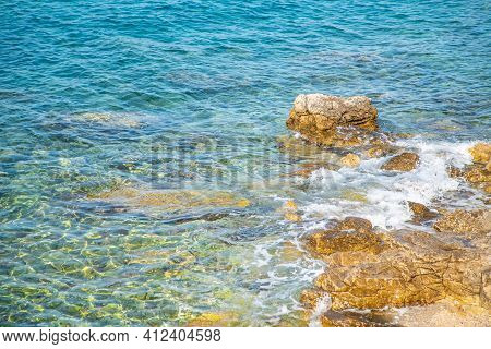 Rocky Shore Near The Blue Sea. Nature Background.