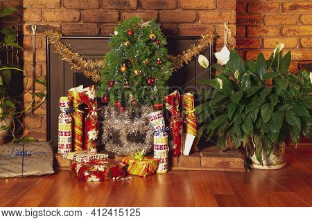 Vintage House Decorated With Small Christmas Tree Placed In Front Of A Fireplace. The Gifts Are Arra