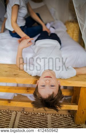 Angry Mother Scolding A Disobedient Child Lies Head Down