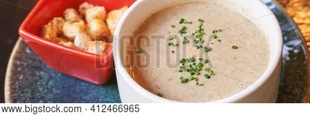 Creamy Onion Soup With Green. Health Food At Cafe. Classic Cuisine. Cooking Bowl With Bread Croutons