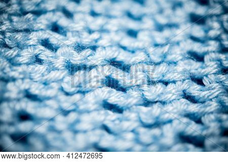 An Extreme Close-up Shot With Selective Focus Of A Piece Of Deep Blue Knitted Fabric.