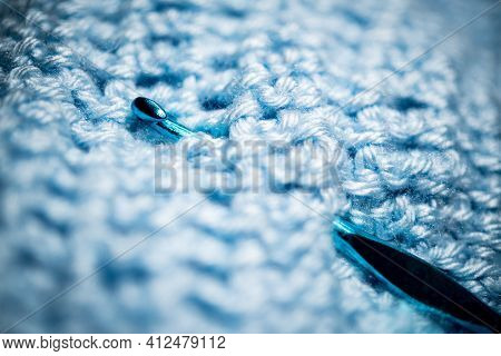An Extreme Close-up Shot With Selective Focus Of A Piece Of Deep Blue Knitted Fabric With Blue Croch