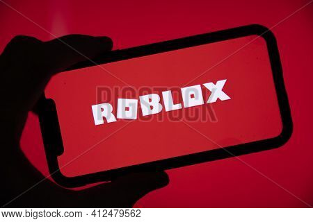 London, Uk - March 2021: Person Holding A Smartphone With Roblox Game Logo