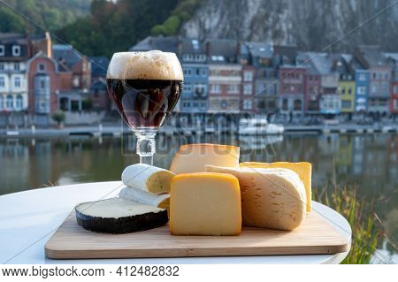 Glass Of Belgian Abbey Beer And Tasting Of Cheeses Made With Trappist Beer And Fine Herbs With View