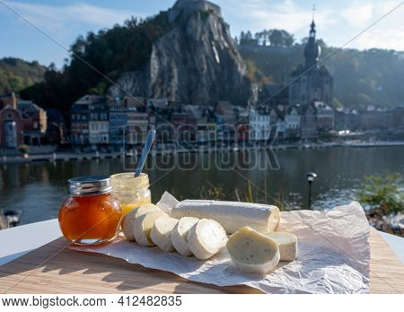 Belgian Abbey Cheese Fagotin In Pieces With Jam Served Outdoor With View On Maas River And Center Of