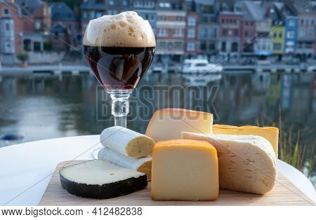 Glass Of Belgian Abbey Beer And Tasting Of Cheeses Made With Trappist Beer And Fine Herbs With View