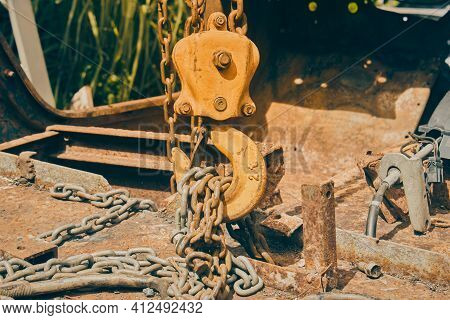 Front View Reel And Chain And U Bolt On Rusty Old Car Interior In Vintage Tone