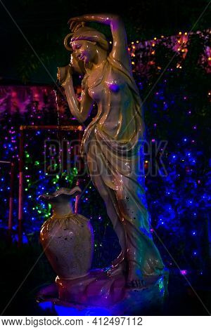 Fountain Statue Of A Young Lady Fetching Water With Small Pot And Pouring Into A Large Water Jar