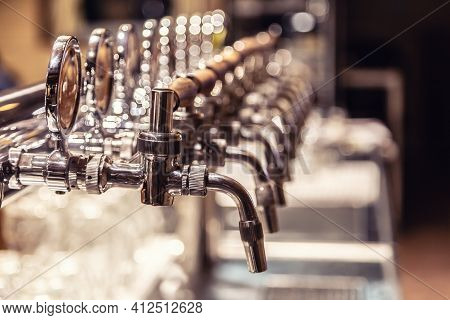Broad Variety Of Draft Beer Pipes In A Pub Ready For Serving Beer.
