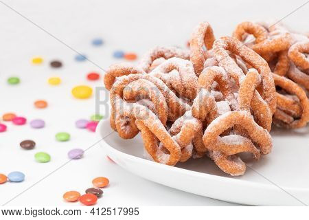 Traditional Finnish May Day Funnel Cake (tippaleipa) On The White Plate With Colorful Small Candies.