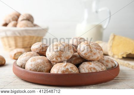 Plate With Tasty Homemade Gingerbread Cookies On White Wooden Table